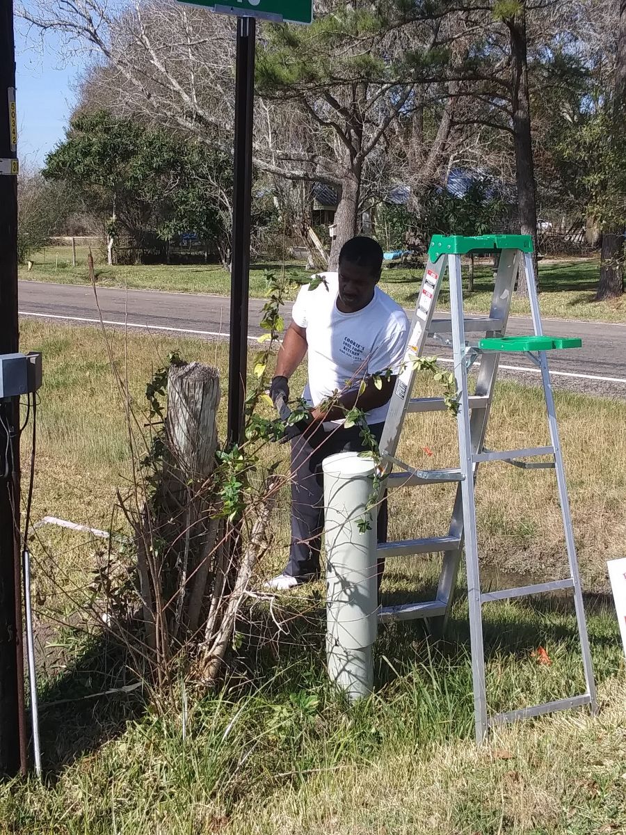 Mayor Gilmore working hard to make sure all sign poles are cleaned up.